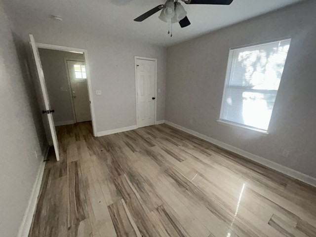 807 Erin Street El Campo, TX 77437 - Photo 13 of 13 wooden floor in an empty room with a window