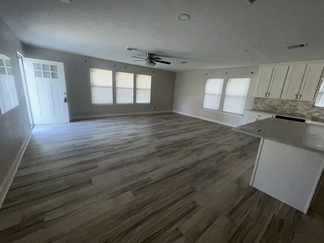 807 Erin Street El Campo, TX 77437 - Photo 4 of 13 a view of a room with wooden floor and a ceiling fan