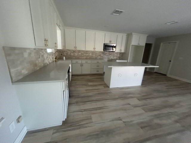 807 Erin Street El Campo, TX 77437 - Photo 6 of 13 a kitchen with stainless steel appliances cabinets a sink and a stove