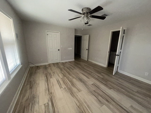 807 Erin Street El Campo, TX 77437 - Photo 8 of 13 wooden floor in an empty room with a window