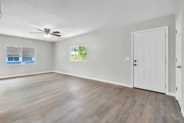 an empty room with windows and closet