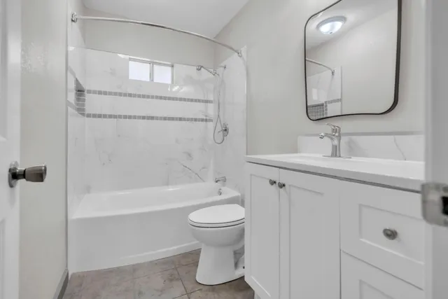 a bathroom with a toilet a sink and bathtub