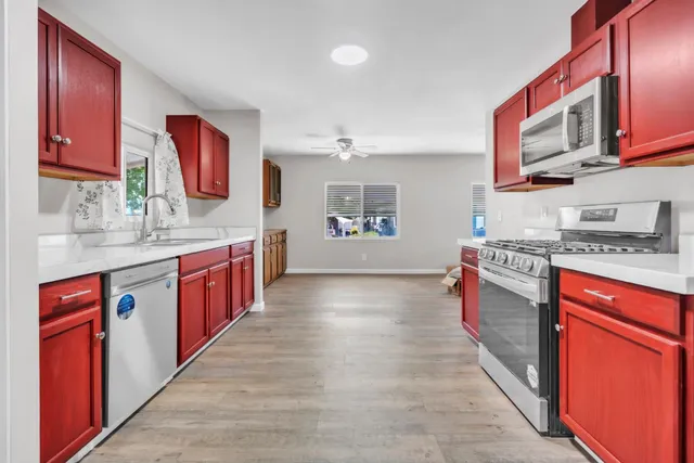 a kitchen with stainless steel appliances granite countertop a stove sink and cabinets