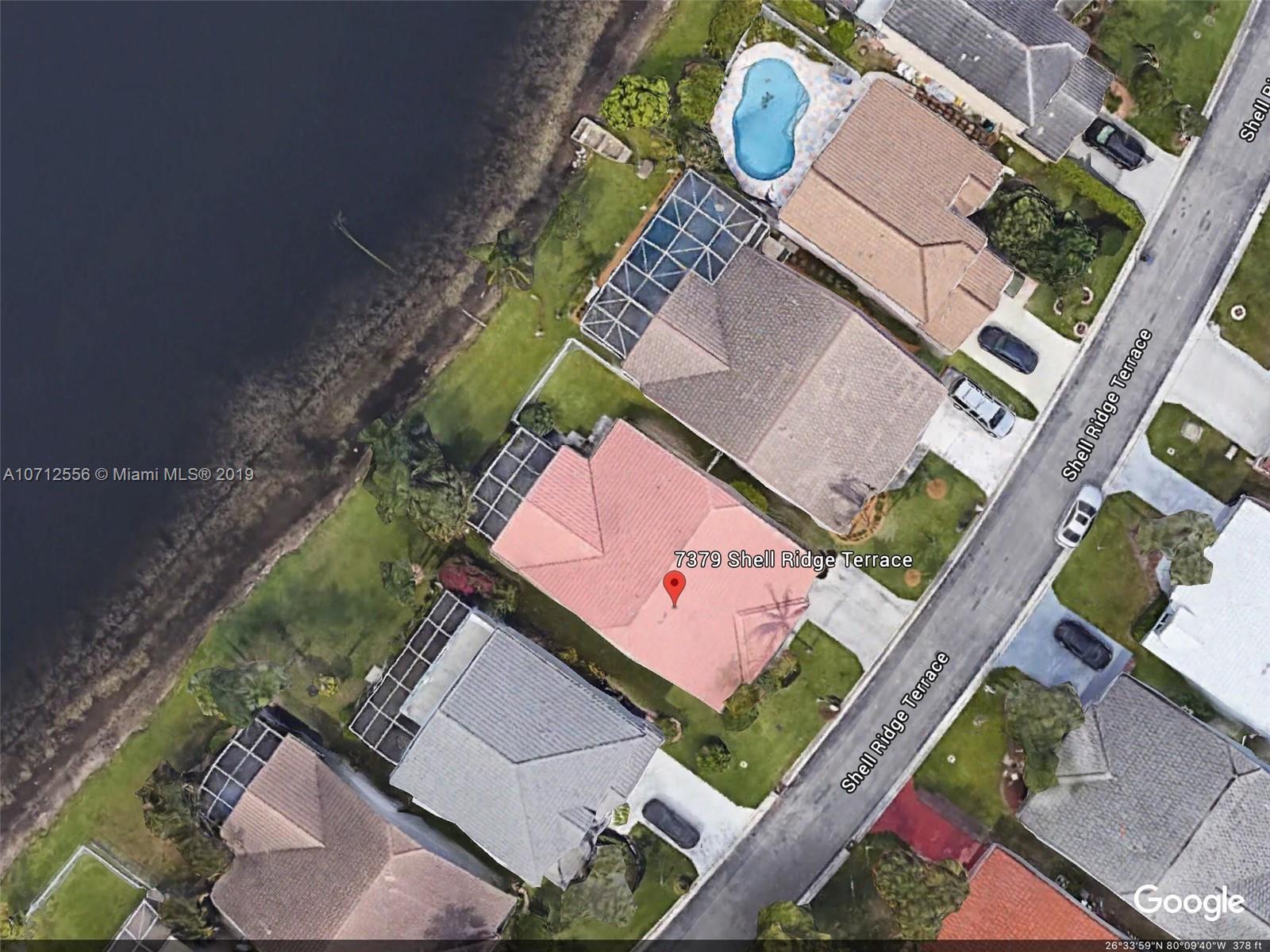 7379 Shell Ridge Terrace Lake Worth, FL 33467 - Photo 1 of 22 an aerial view of a house