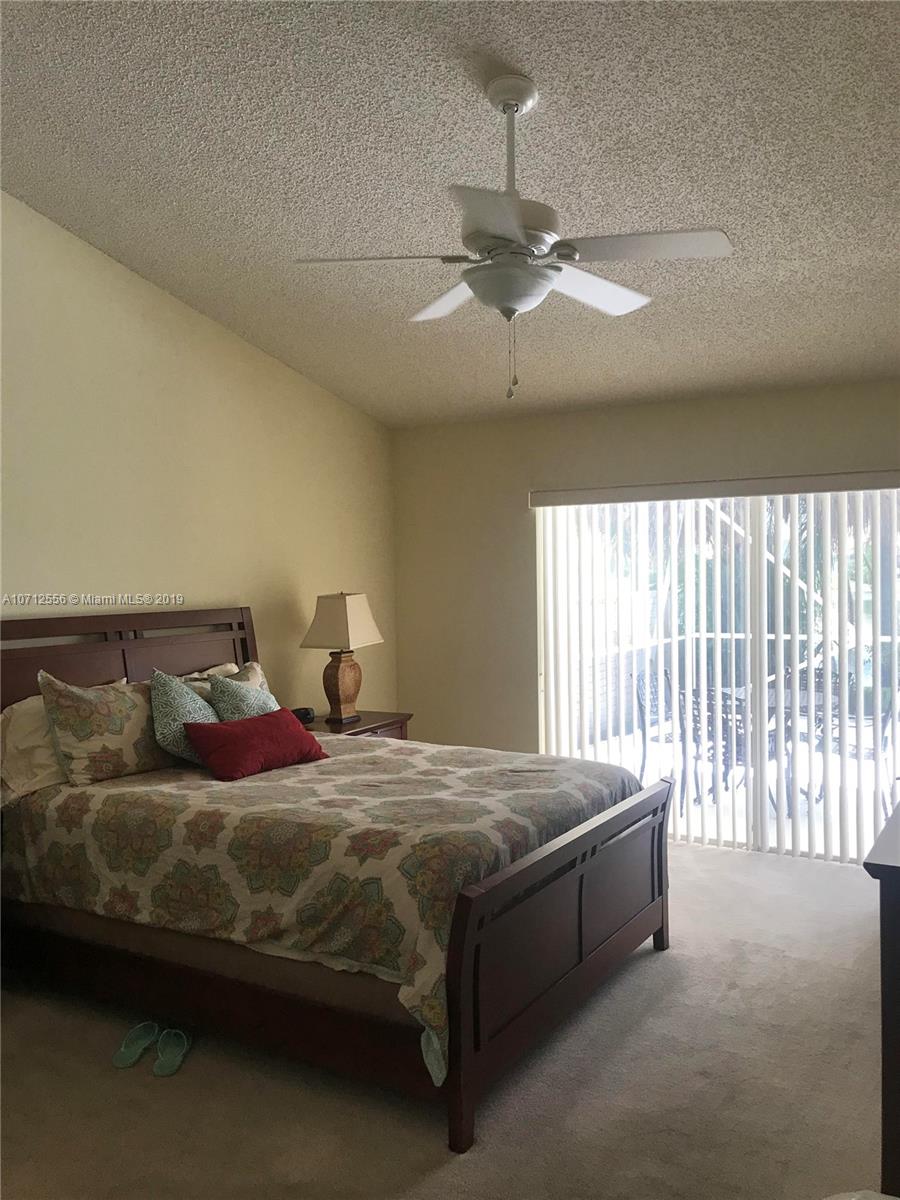 7379 Shell Ridge Terrace Lake Worth, FL 33467 - Photo 12 of 22 a bedroom with a bed and window