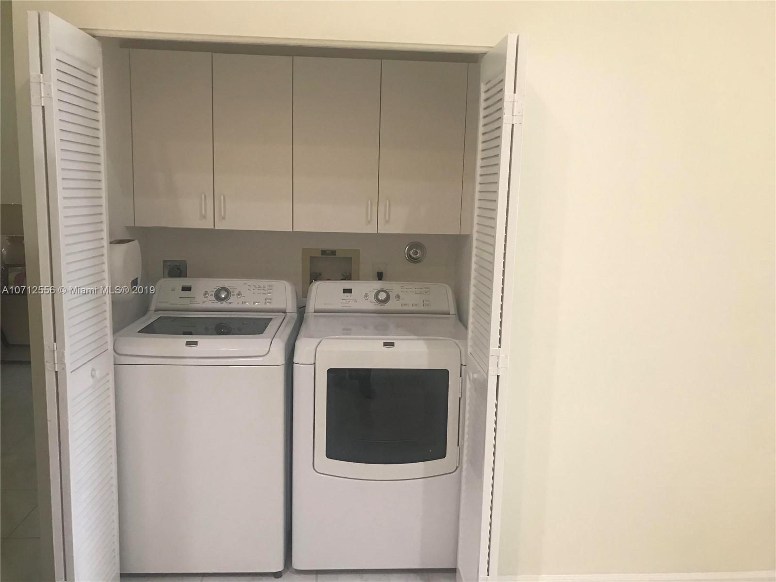 7379 Shell Ridge Terrace Lake Worth, FL 33467 - Photo 18 of 22 a utility room with dryer and washer