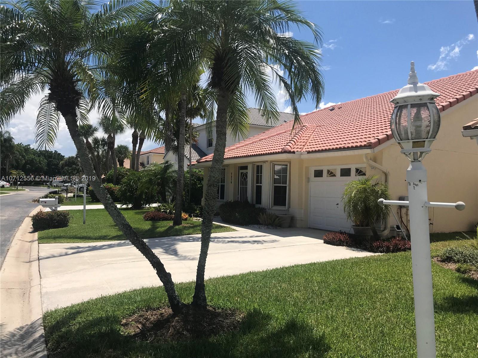 7379 Shell Ridge Terrace Lake Worth, FL 33467 - Photo 2 of 22 a view of a house with backyard and sitting area