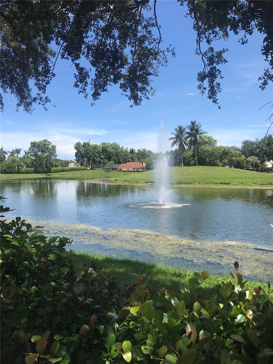 7379 Shell Ridge Terrace Lake Worth, FL 33467 - Photo 22 of 22 a view of a lake with houses in the back
