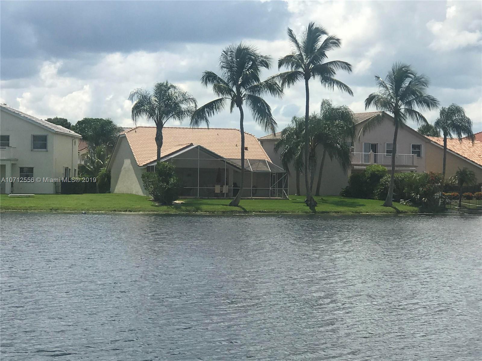 7379 Shell Ridge Terrace Lake Worth, FL 33467 - Photo 5 of 22 a palm tree sitting in a yard with a house