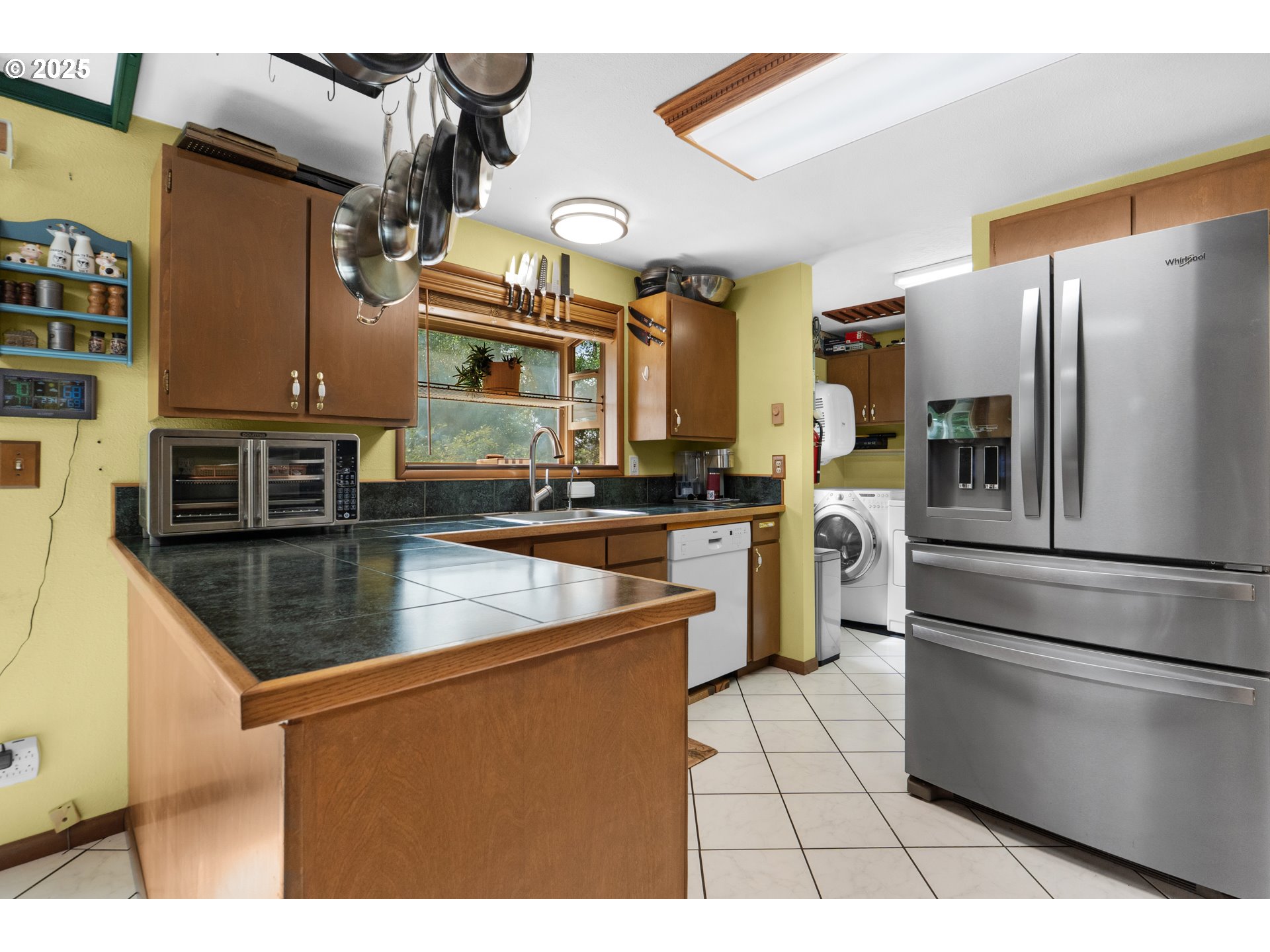 89869 Highway 202 Astoria, OR 97103 - Photo 11 of 30 a kitchen with stainless steel appliances granite countertop a refrigerator a stove a sink and a microwave
