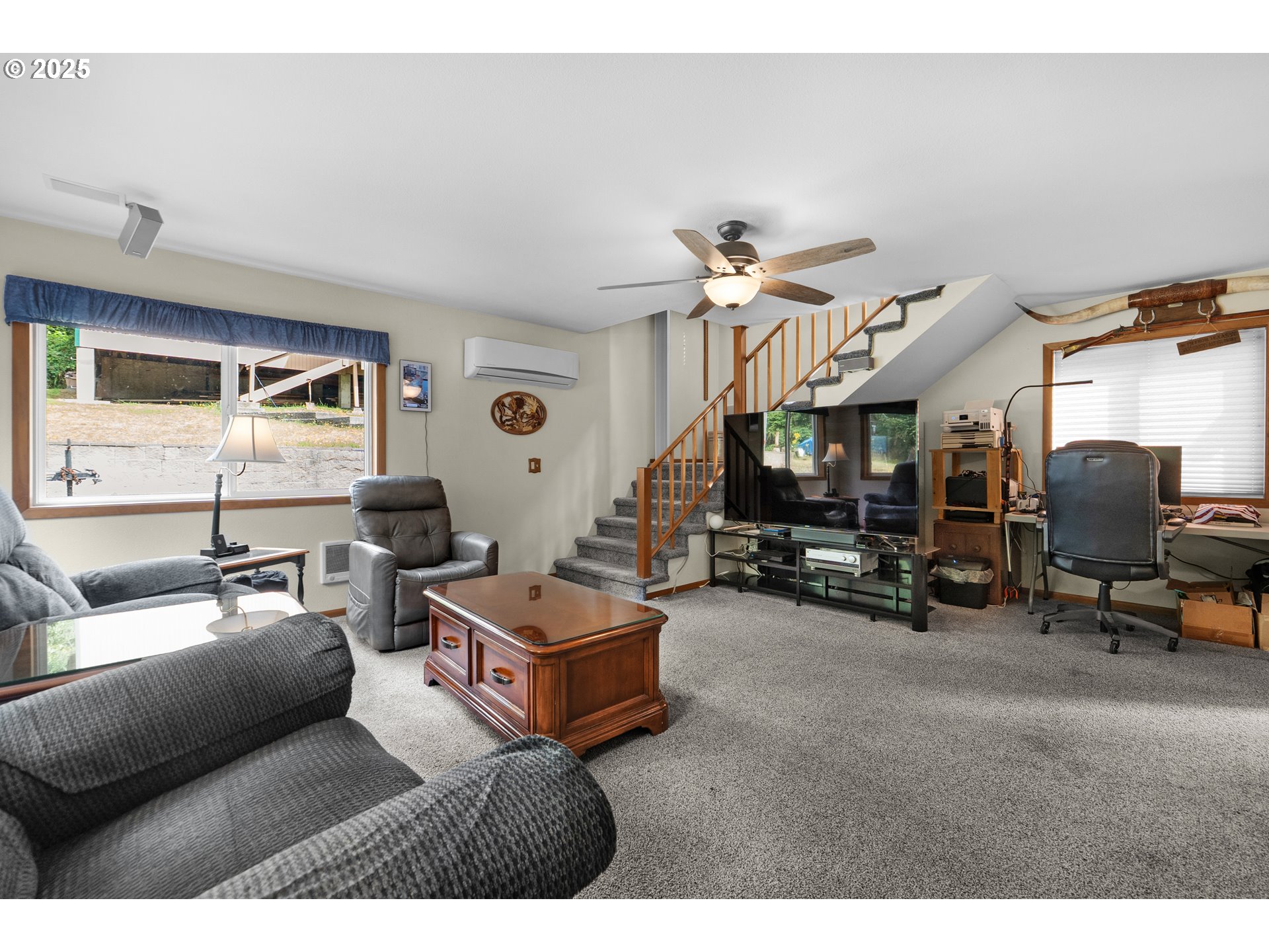 89869 Highway 202 Astoria, OR 97103 - Photo 20 of 30 a living room with furniture a ceiling fan and a rug