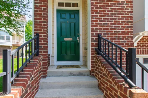 a view of a hallway with wooden floor and entryway