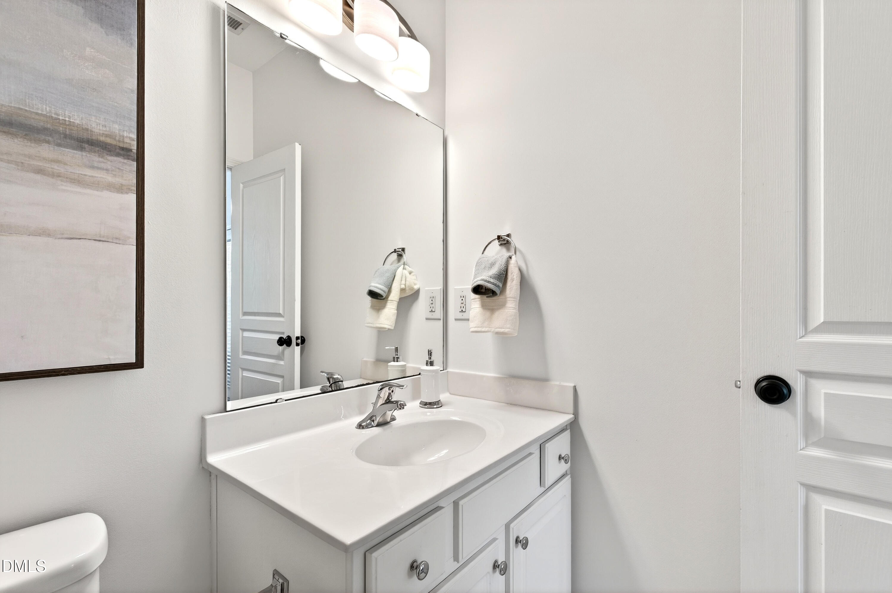 5415 Crescentview Parkway Raleigh, NC 27606 - Photo 19 of 64 a bathroom with a sink and a mirror