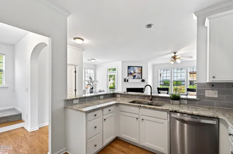 a dining room with furniture a chandelier and wooden floor