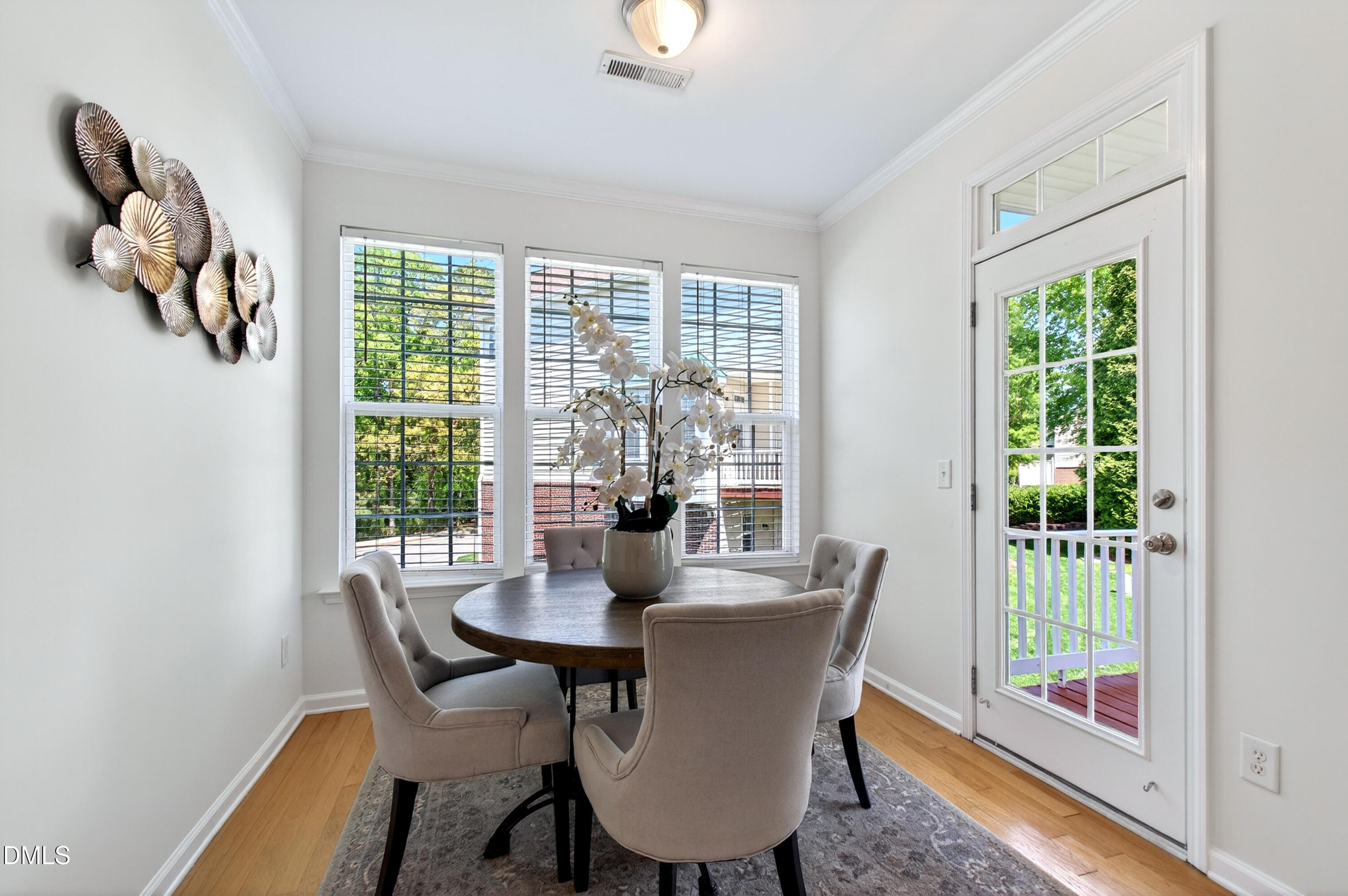 5415 Crescentview Parkway Raleigh, NC 27606 - Photo 35 of 64 a dining room with furniture a chandelier and wooden floor