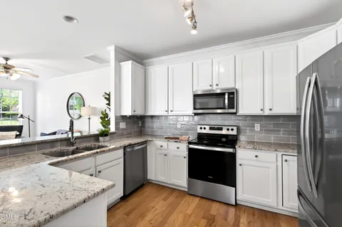 a kitchen with a sink stove and refrigerator