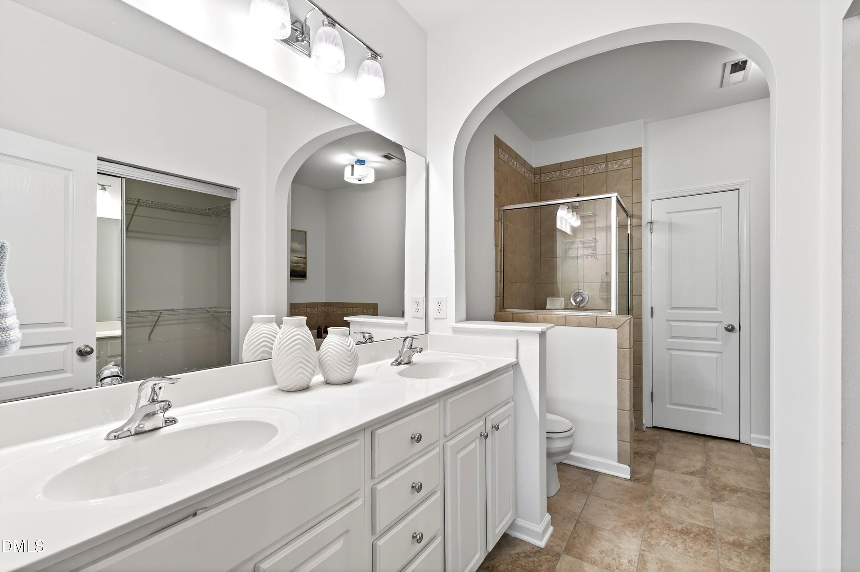 5415 Crescentview Parkway Raleigh, NC 27606 - Photo 6 of 64 a bathroom with double vanity sinks and a mirror