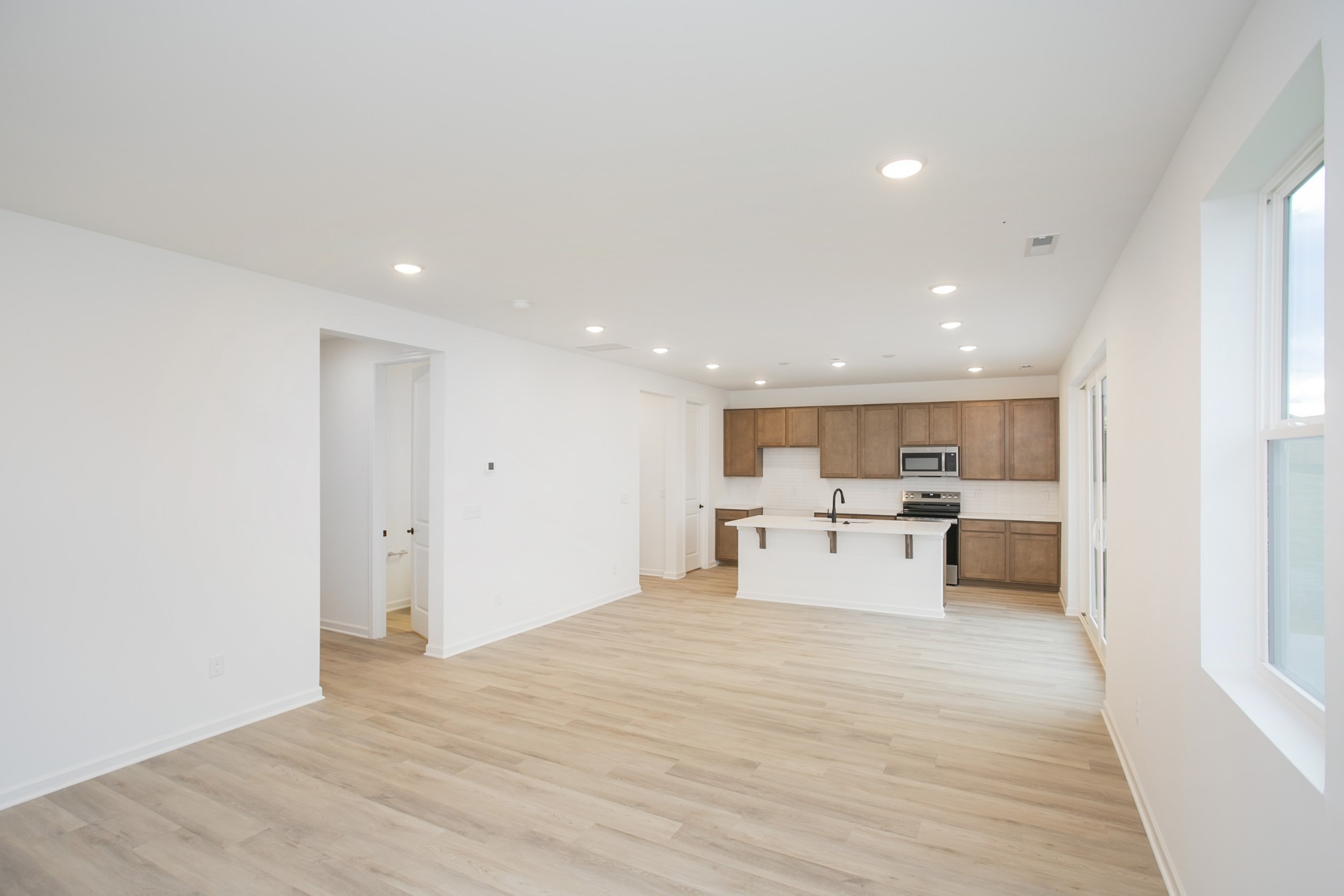 711 Chestnut Bend Dickson, TN 37055 - Photo 12 of 29 a view of a living room kitchen with stainless steel appliances cabinets