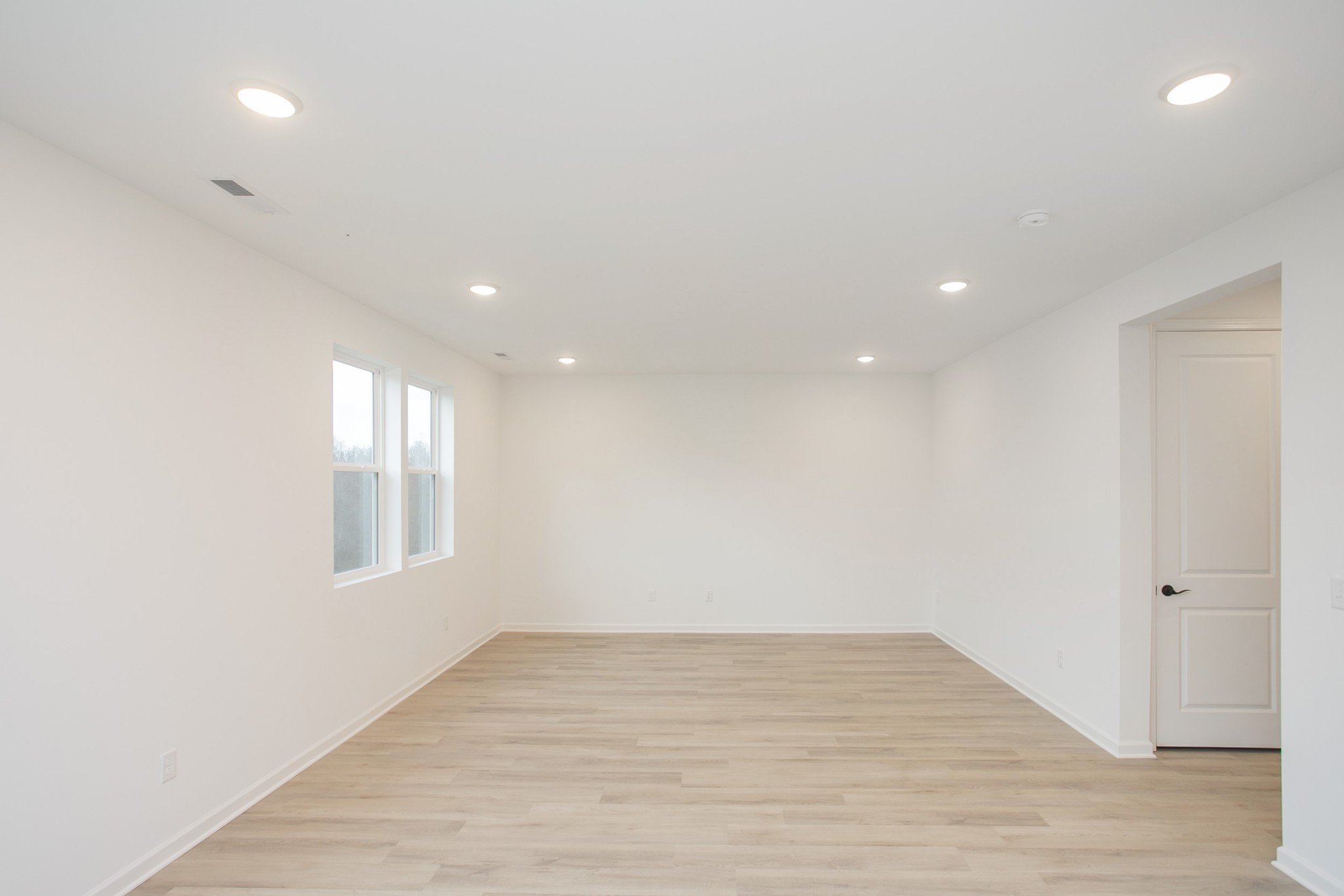 711 Chestnut Bend Dickson, TN 37055 - Photo 13 of 29 an empty room with wooden floor and windows