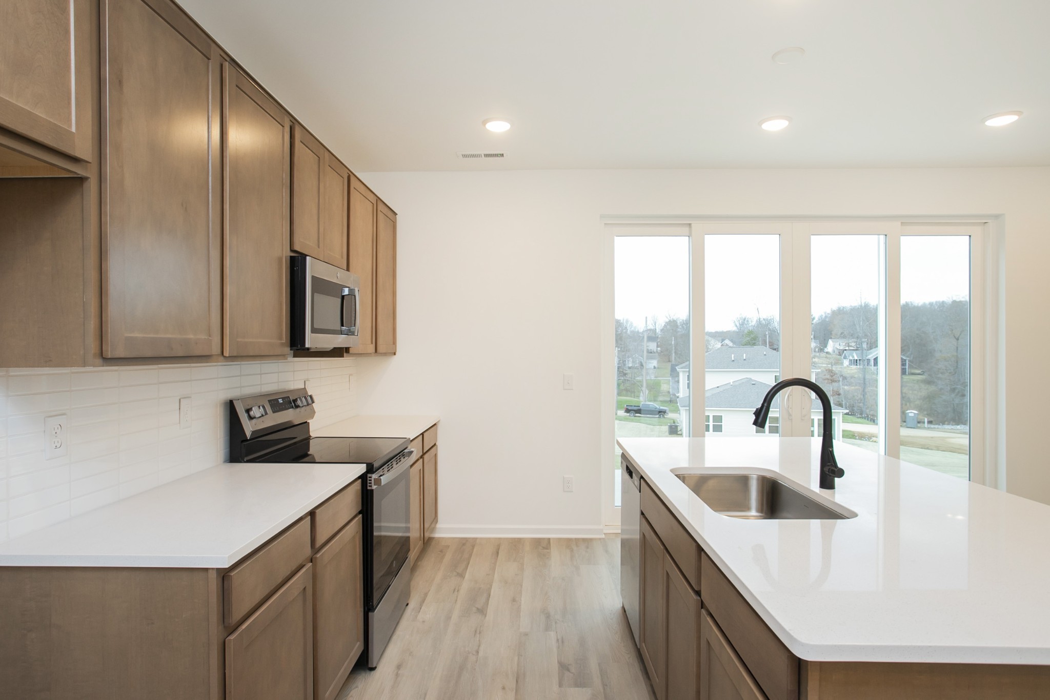 711 Chestnut Bend Dickson, TN 37055 - Photo 22 of 29 a kitchen with stainless steel appliances a sink a stove and a refrigerator