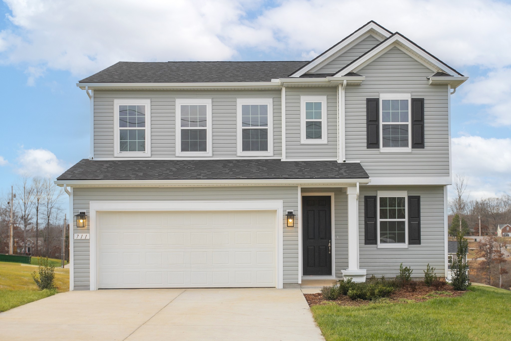 711 Chestnut Bend Dickson, TN 37055 - Photo 3 of 29 a front view of a house with a yard and garage