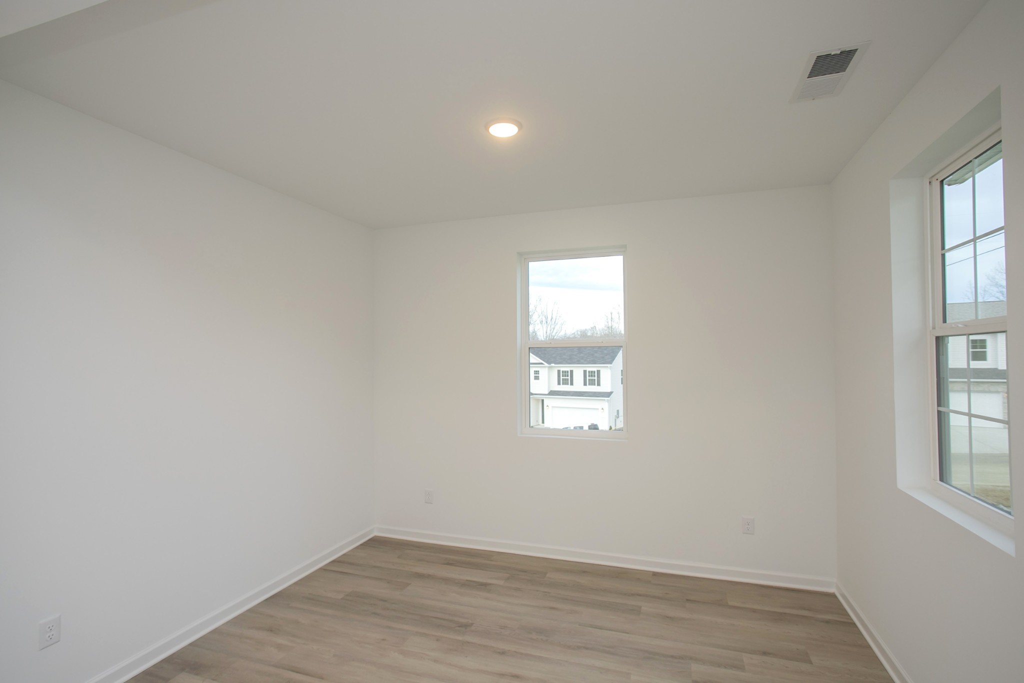 711 Chestnut Bend Dickson, TN 37055 - Photo 8 of 29 an empty room with wooden floor and windows