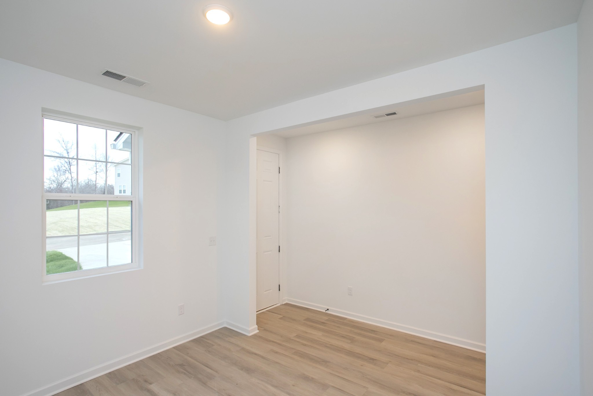 711 Chestnut Bend Dickson, TN 37055 - Photo 9 of 29 an empty room with wooden floor and windows