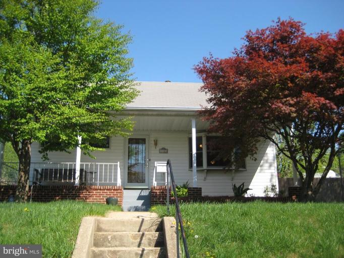 727 Cliffedge Road Pikesville, MD 21208 - Photo 1 of 14 a front view of a house with a yard porch and sitting area