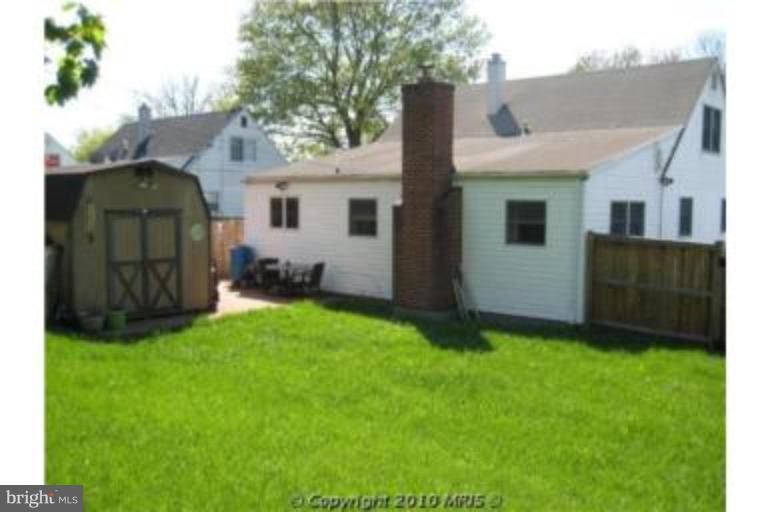 727 Cliffedge Road Pikesville, MD 21208 - Photo 2 of 14 a view of a backyard with potted plants and large tree