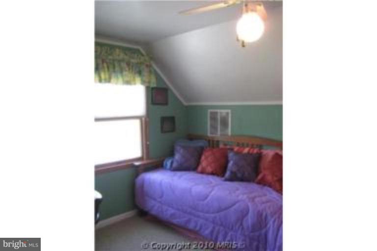 727 Cliffedge Road Pikesville, MD 21208 - Photo 12 of 14 a bedroom with a bed and a window