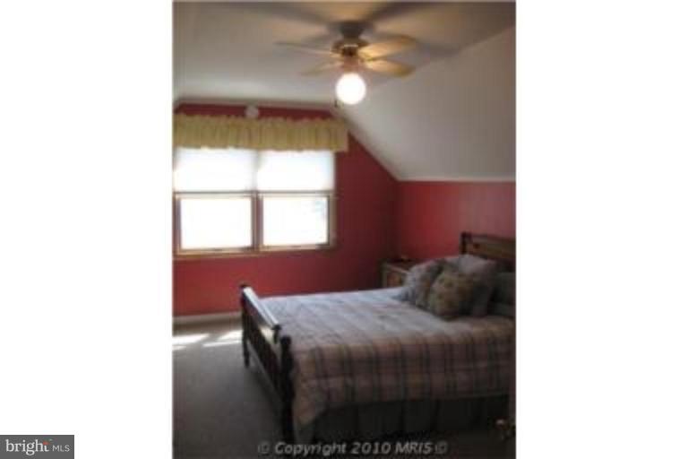 727 Cliffedge Road Pikesville, MD 21208 - Photo 13 of 14 a bedroom with a bed and a window