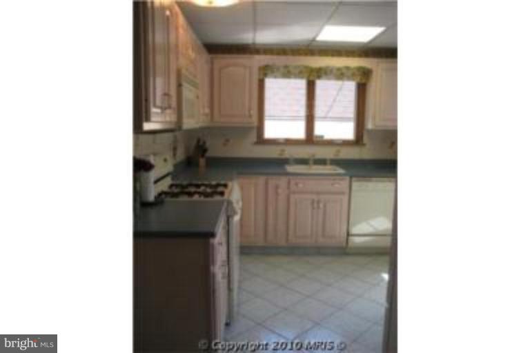 727 Cliffedge Road Pikesville, MD 21208 - Photo 5 of 14 a kitchen with a sink cabinets and a window