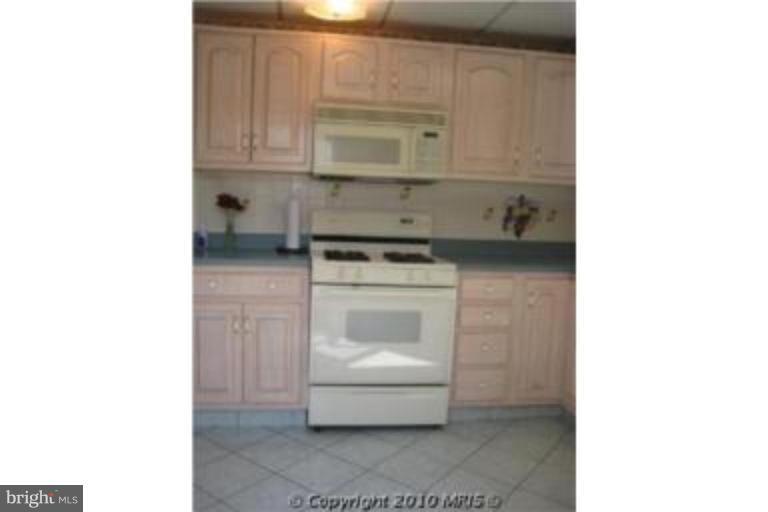 727 Cliffedge Road Pikesville, MD 21208 - Photo 6 of 14 a utility room with sink and cabinets