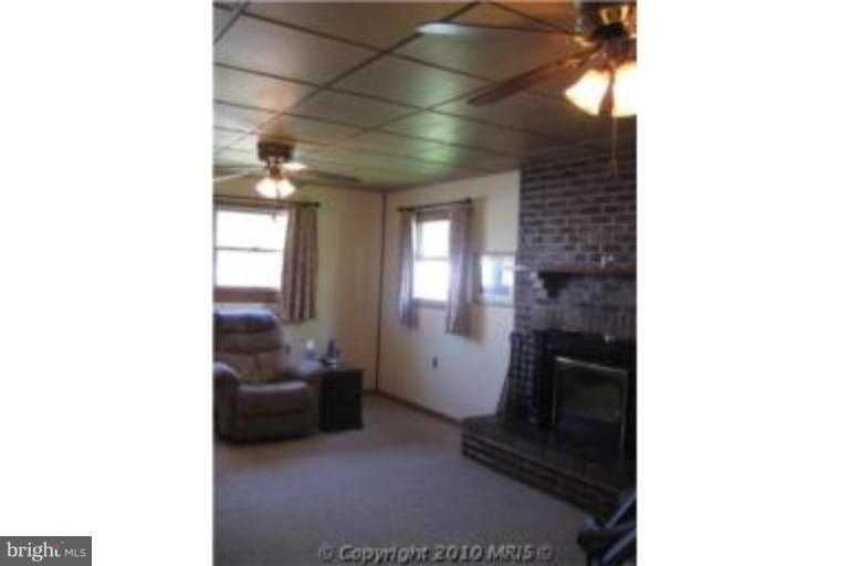 727 Cliffedge Road Pikesville, MD 21208 - Photo 7 of 14 a picture of a room with a furniture and a fireplace