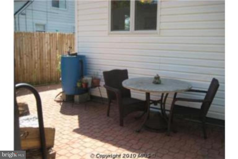 727 Cliffedge Road Pikesville, MD 21208 - Photo 9 of 14 a backyard of a house with table and chairs