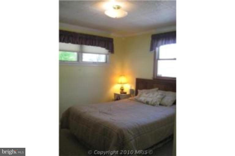 727 Cliffedge Road Pikesville, MD 21208 - Photo 10 of 14 a bedroom with a bed and a window