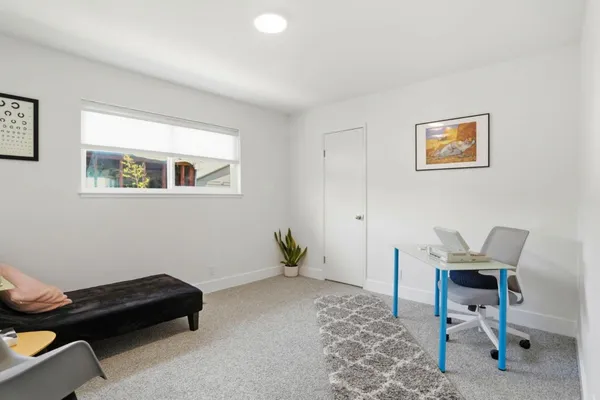 a bedroom with a bed and chair
