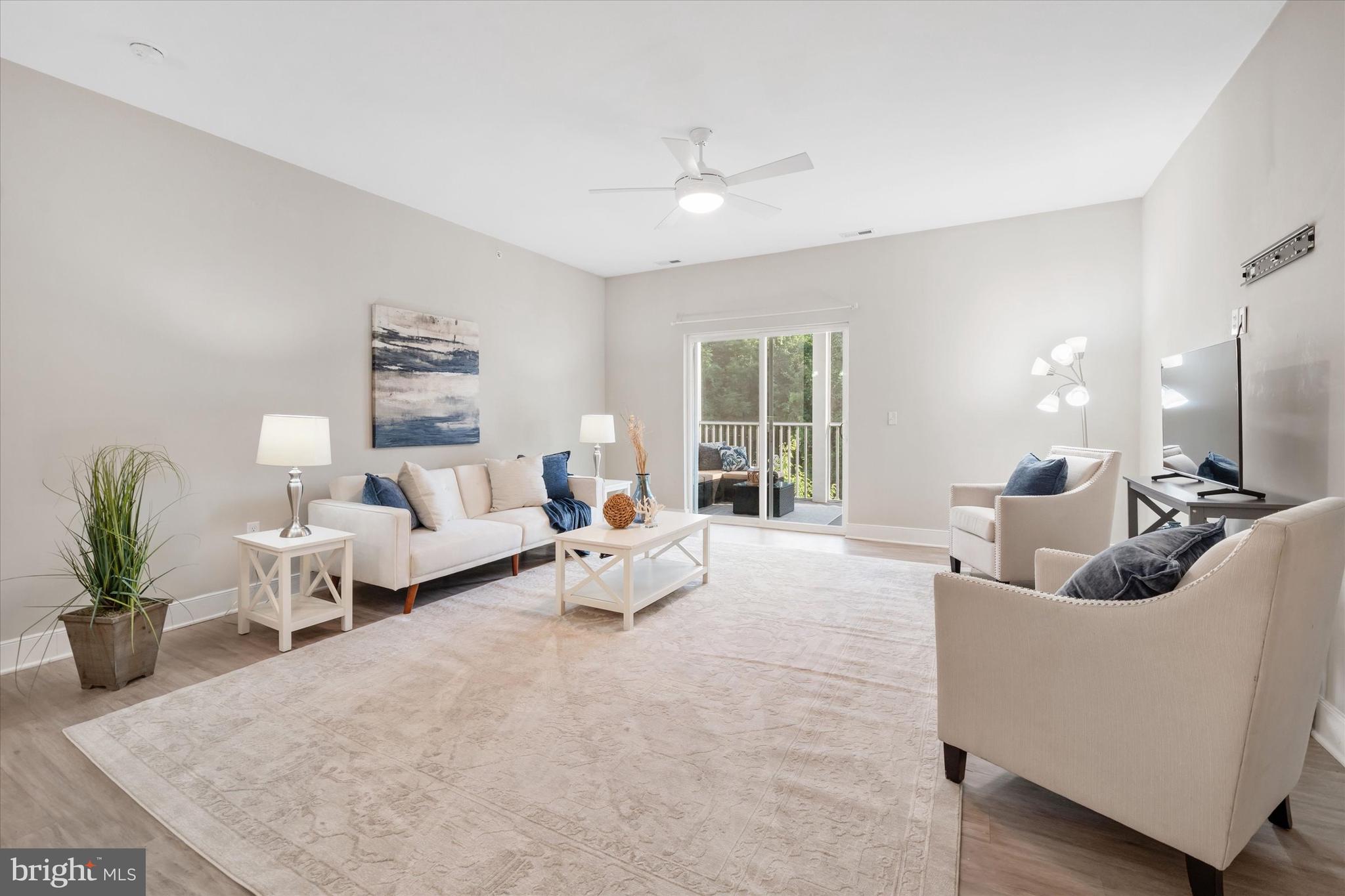 30609 Cedar Neck Road, Unit 3205 Ocean View, DE 19970 - Photo 11 of 28 a living room with furniture and a large window