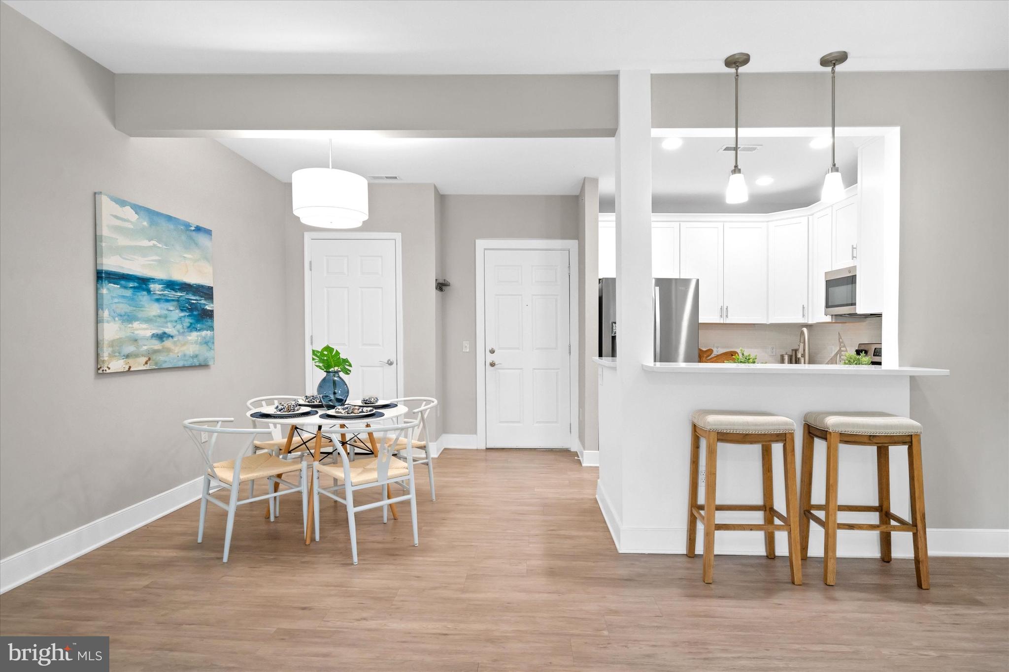 30609 Cedar Neck Road, Unit 3205 Ocean View, DE 19970 - Photo 15 of 28 a dining room with wooden floor and large window