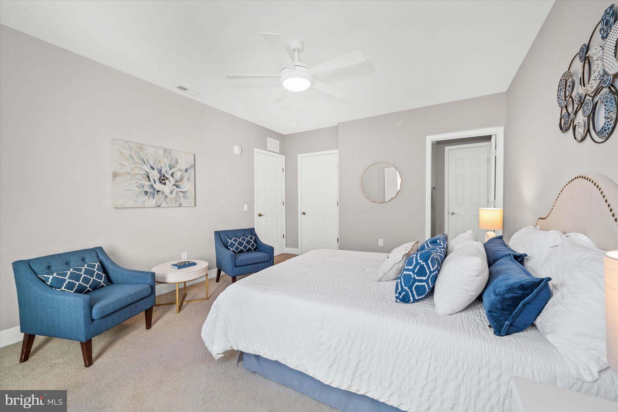 30609 Cedar Neck Road, Unit 3205 Ocean View, DE 19970 - Photo 20 of 28 a bedroom with a bed and a painting on the wall