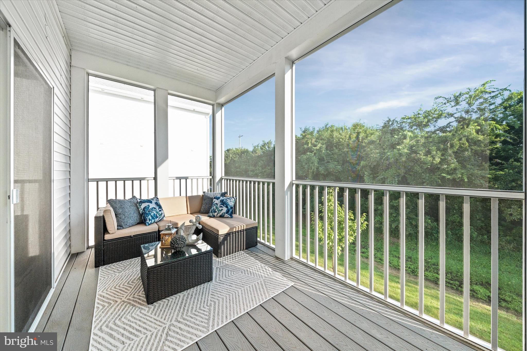 30609 Cedar Neck Road, Unit 3205 Ocean View, DE 19970 - Photo 2 of 28 a balcony with furniture and floor to ceiling windows