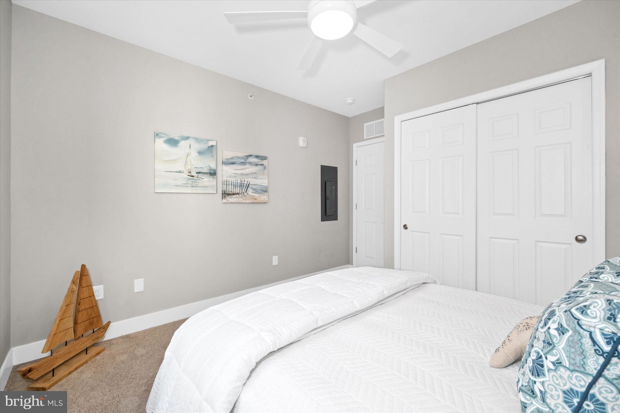 30609 Cedar Neck Road, Unit 3205 Ocean View, DE 19970 - Photo 26 of 28 a bedroom with a bed and a painting on the wall