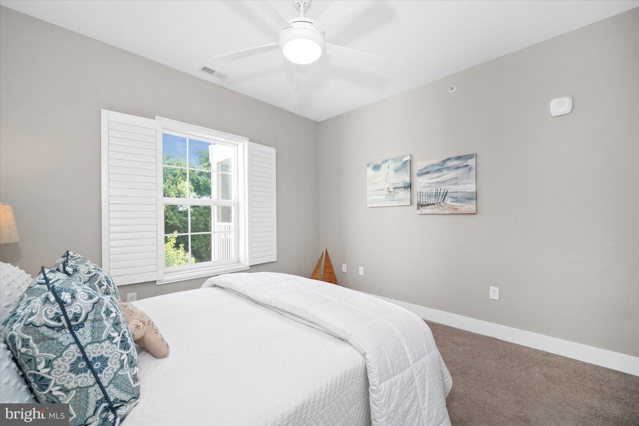 30609 Cedar Neck Road, Unit 3205 Ocean View, DE 19970 - Photo 27 of 28 a bedroom with a large bed and a window