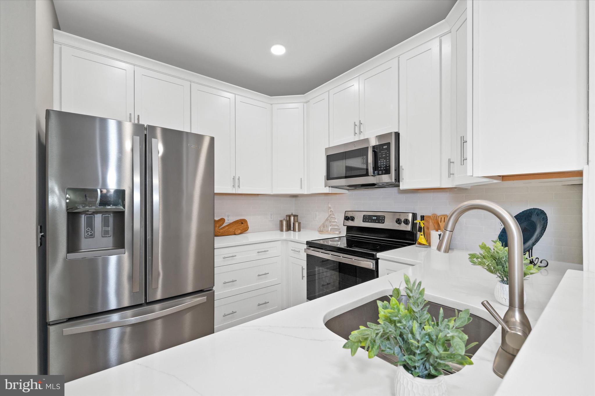 30609 Cedar Neck Road, Unit 3205 Ocean View, DE 19970 - Photo 8 of 28 a kitchen with stainless steel appliances granite countertop a refrigerator sink and stove