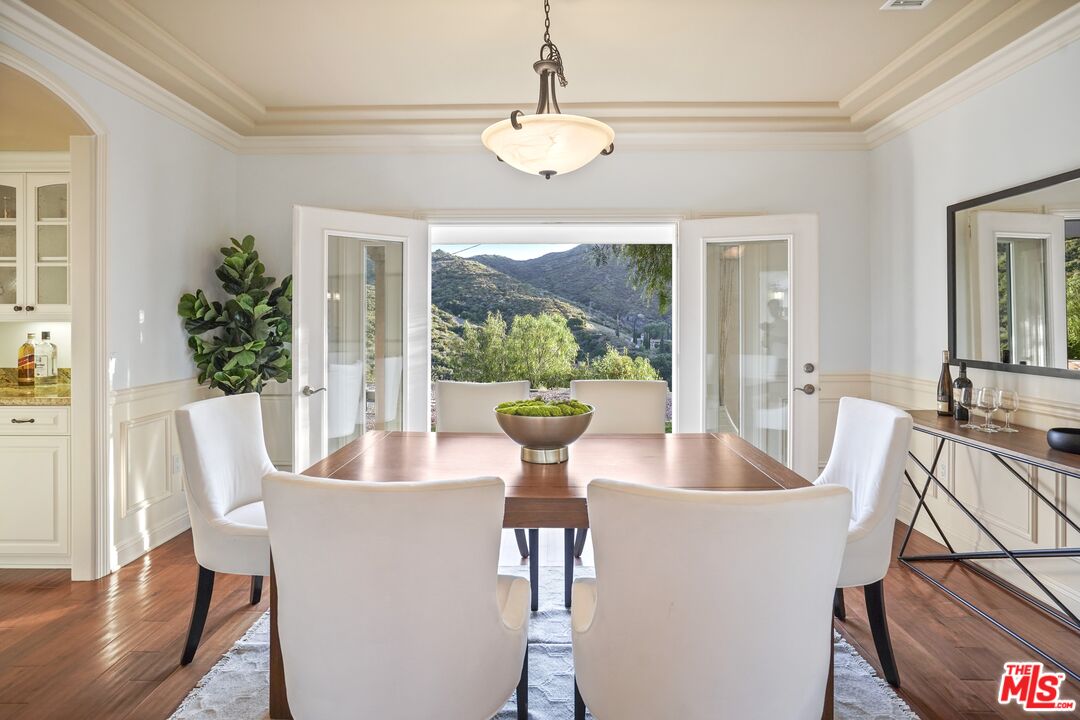 969 Crown Hill Drive Simi Valley, CA 93063 - Photo 13 of 62 a dining room with furniture a chandelier and wooden floor