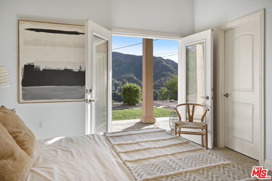 969 Crown Hill Drive Simi Valley, CA 93063 - Photo 22 of 62 a view of a bedroom with furniture and a porch