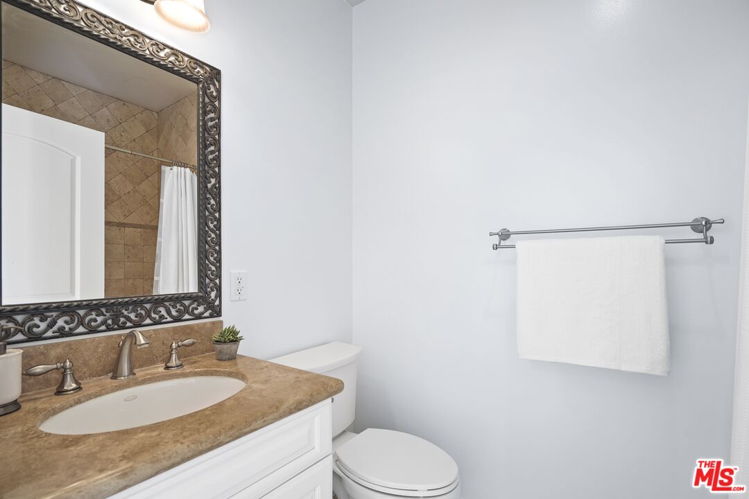 969 Crown Hill Drive Simi Valley, CA 93063 - Photo 23 of 62 a bathroom with a granite countertop sink toilet and shower