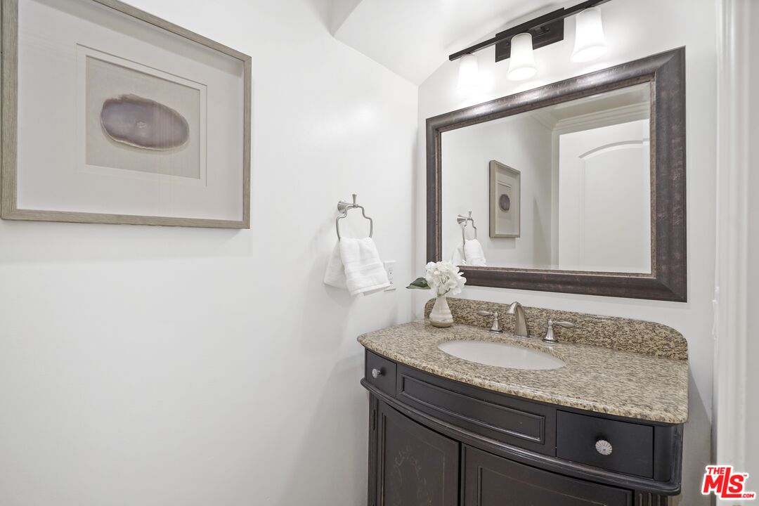 969 Crown Hill Drive Simi Valley, CA 93063 - Photo 25 of 62 a bathroom with a granite countertop sink and a mirror