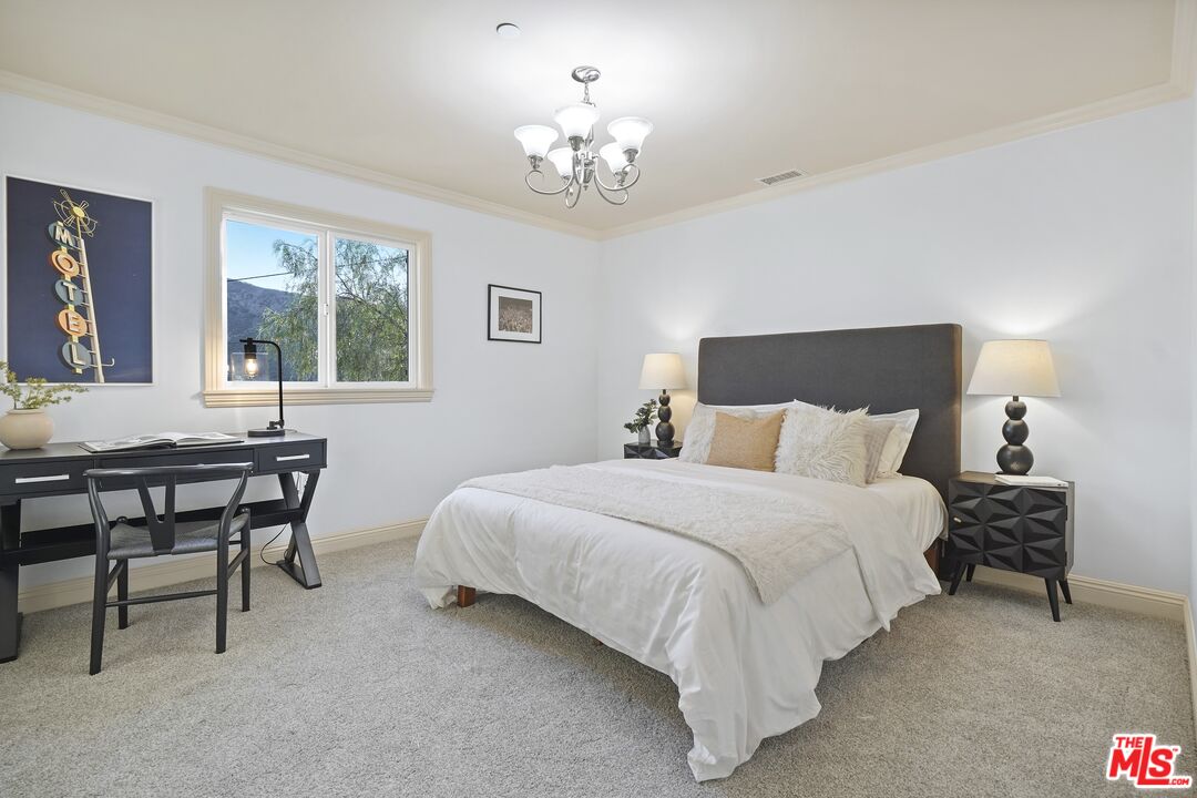 969 Crown Hill Drive Simi Valley, CA 93063 - Photo 33 of 62 a bedroom with bed and a chandelier