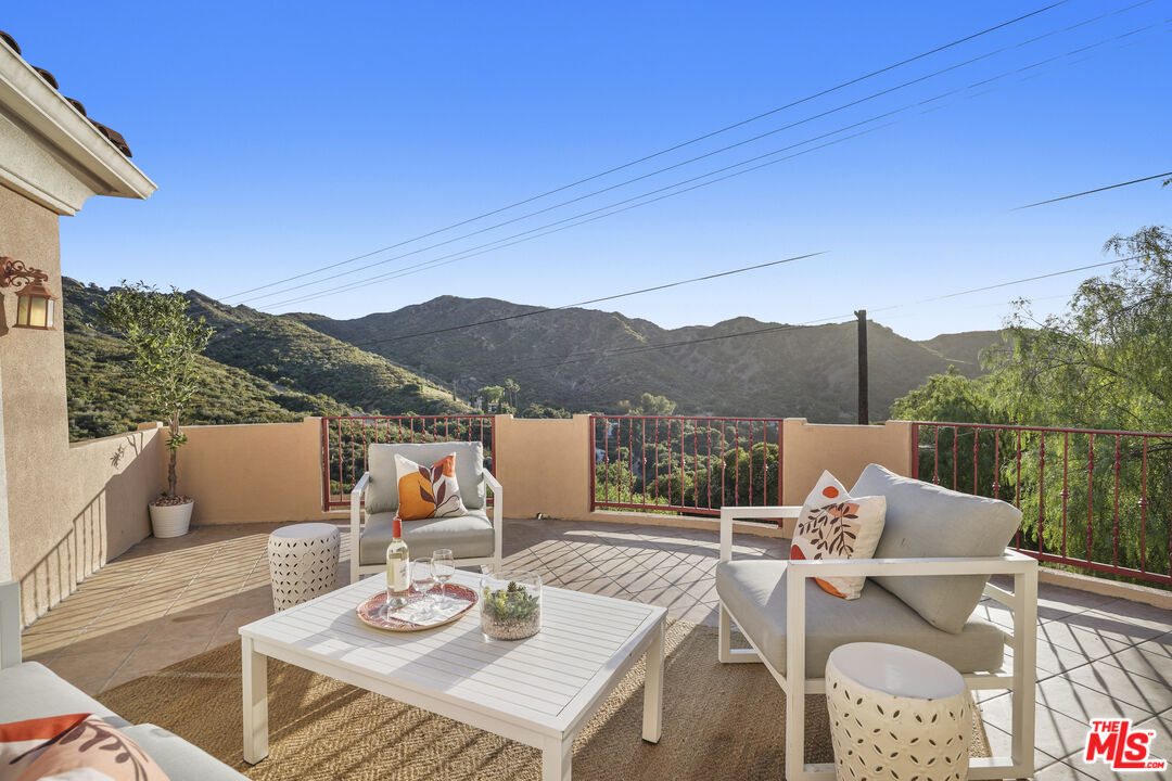 969 Crown Hill Drive Simi Valley, CA 93063 - Photo 37 of 62 a view of a patio with couches table and chairs and wooden floor